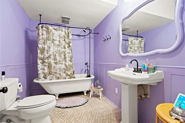 a bathroom with a sink toilet and a mirror