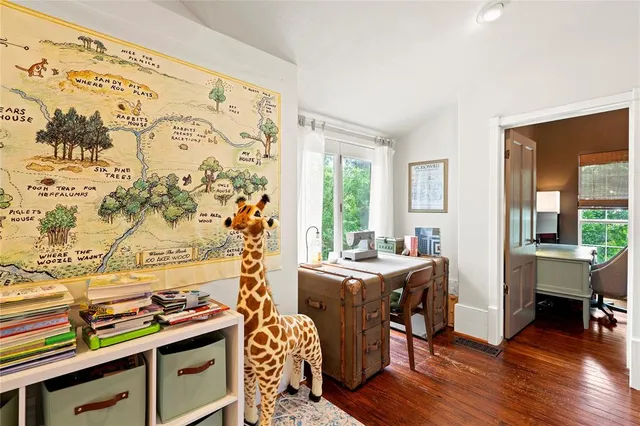 a view of a workspace with furniture and a window