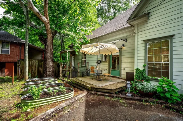 a view of a chair and tables in the backyard