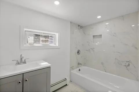 a bathroom with a bathtub sink and toilet