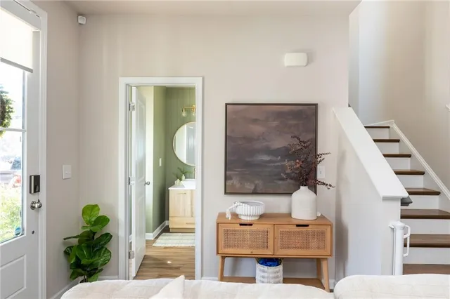 a view of a a dining room with furniture window and wooden floor