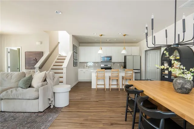 a kitchen with granite countertop a sink stainless steel appliances and cabinets