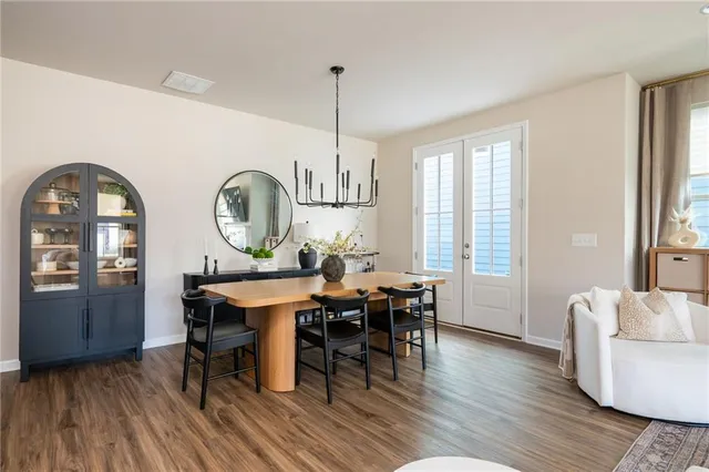 a dining room with furniture and a mirror