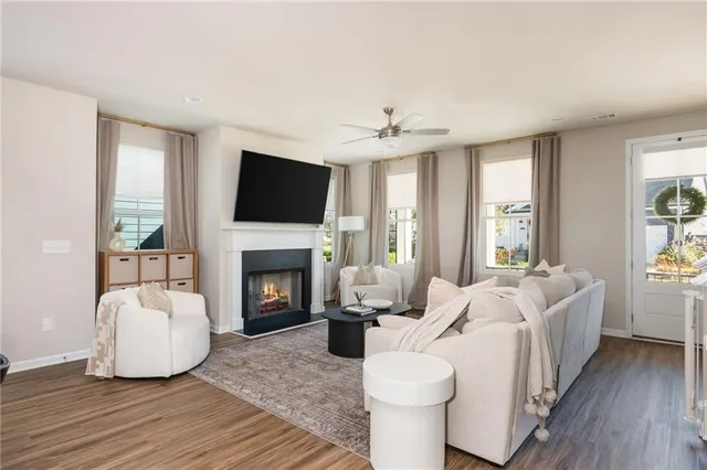 a living room with furniture a fireplace and a flat screen tv
