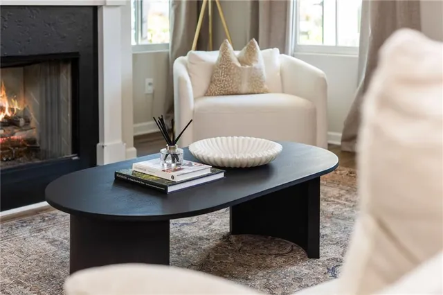 a living room with furniture a fireplace and a flat screen tv