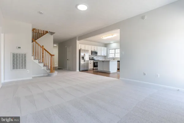 a view of a livingroom with a dinning room and stairs
