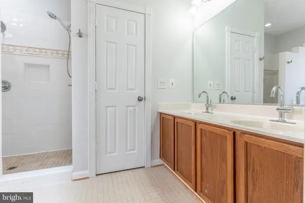 a bathroom with a double vanity sink and a mirror