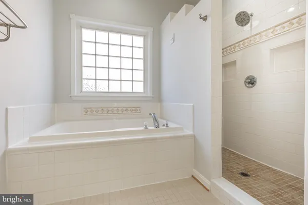 a bathroom with a bathtub and shower
