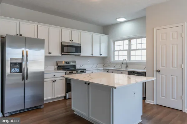 a kitchen with a stove a sink and a refrigerator