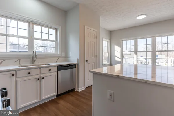 a kitchen with granite countertop a sink and a large window