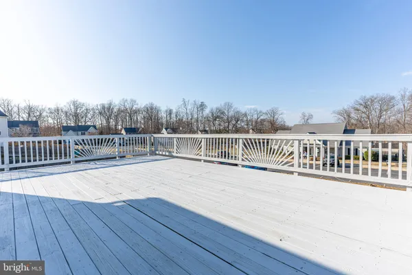 a view of a balcony with wooden floor and fence