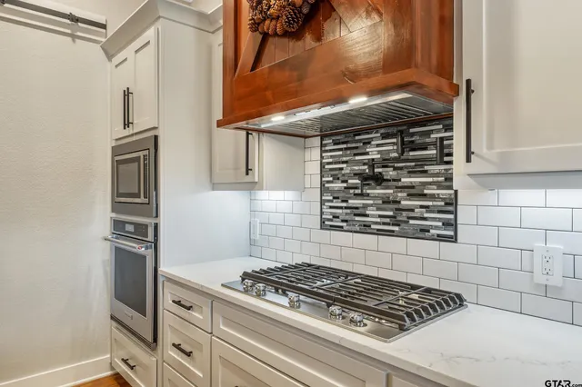 a kitchen with granite countertop stainless steel appliances and cabinets