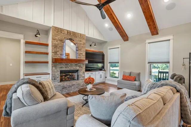 a living room with furniture fireplace and a flat screen tv