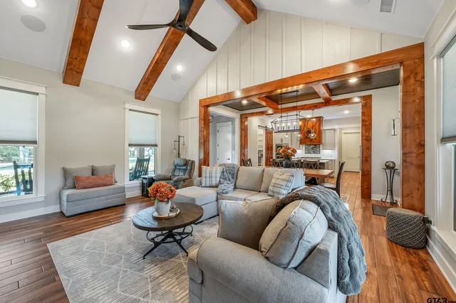 a living room with furniture and wooden floor