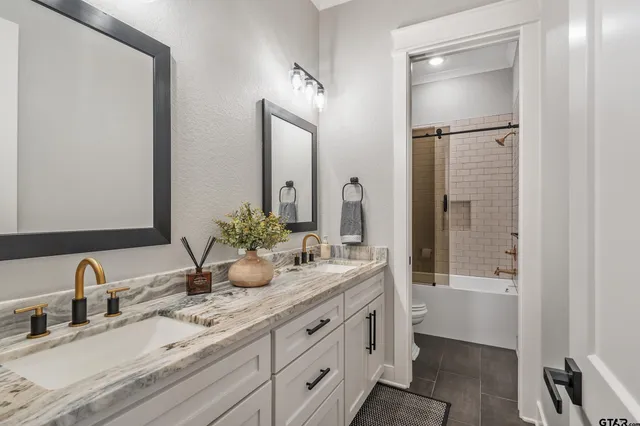 a bathroom with a double vanity sink and a mirror