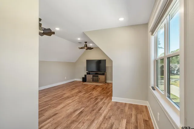 a view of a kitchen with wooden floor and a ceiling fan