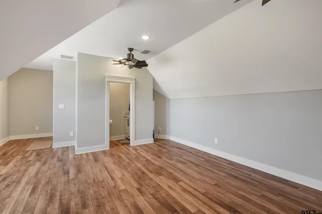 a view of an empty room and wooden floor