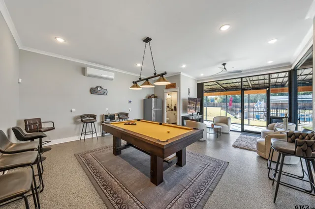 a living room with furniture a rug and a chandelier