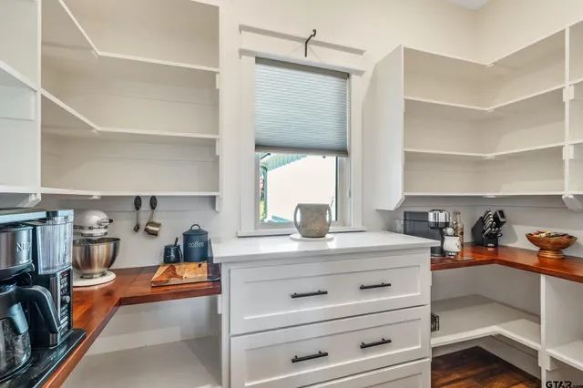 a bathroom with a granite countertop sink and a toilet