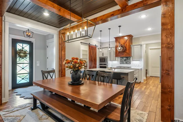 a view of a dining room with furniture and wooden floor