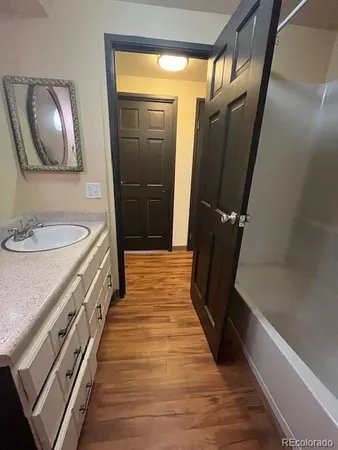 a dining room with furniture and wooden floor