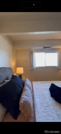 a living room with furniture and a mirror