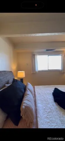 a living room with furniture and a mirror