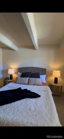 a room with a large window and chandelier