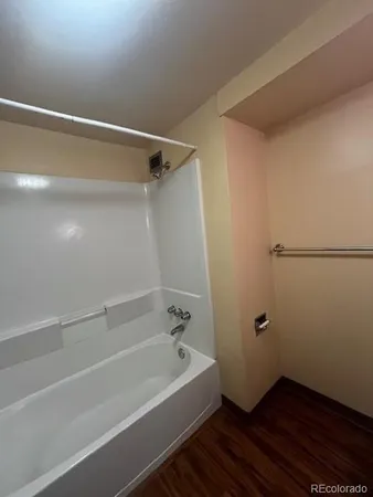 a bathroom with a bathtub and shower