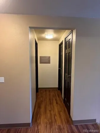 a view of hallway with wooden floor