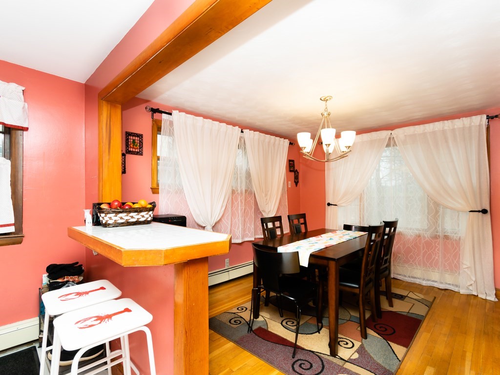 70 Edgemere Road Boston, MA 02132 - Photo 13 of 39 a view of a dining room with furniture and chandelier