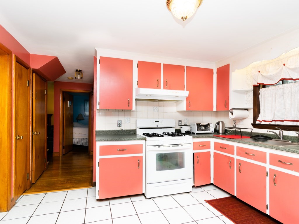 70 Edgemere Road Boston, MA 02132 - Photo 17 of 39 a kitchen with stainless steel appliances granite countertop a stove a sink and a refrigerator