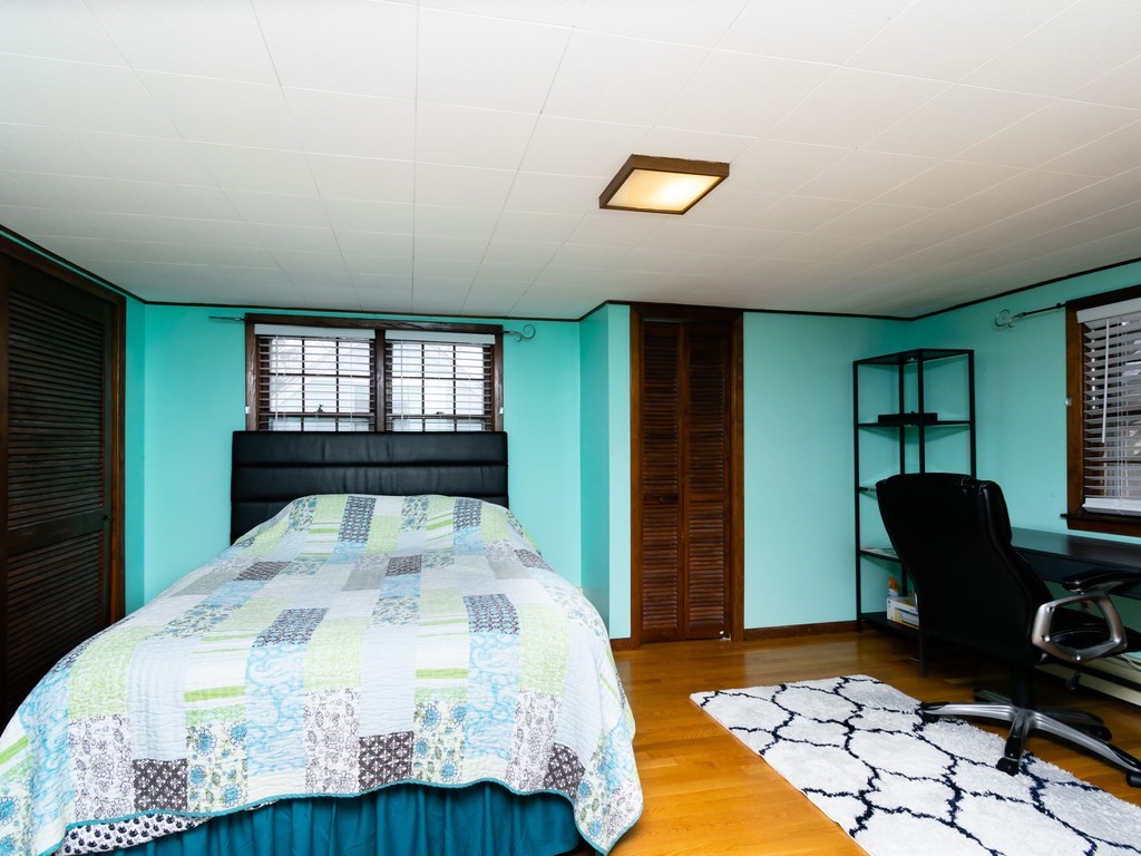 70 Edgemere Road Boston, MA 02132 - Photo 21 of 39 a bedroom with a bed and a dresser
