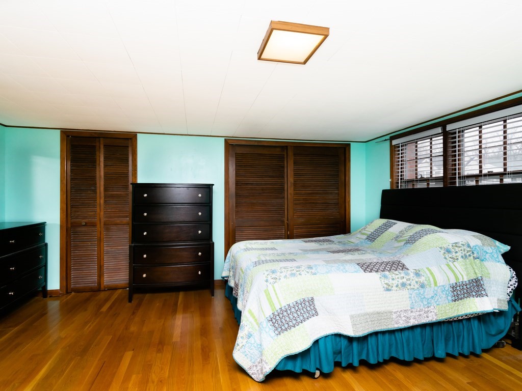70 Edgemere Road Boston, MA 02132 - Photo 22 of 39 a bedroom with a bed and a dresser