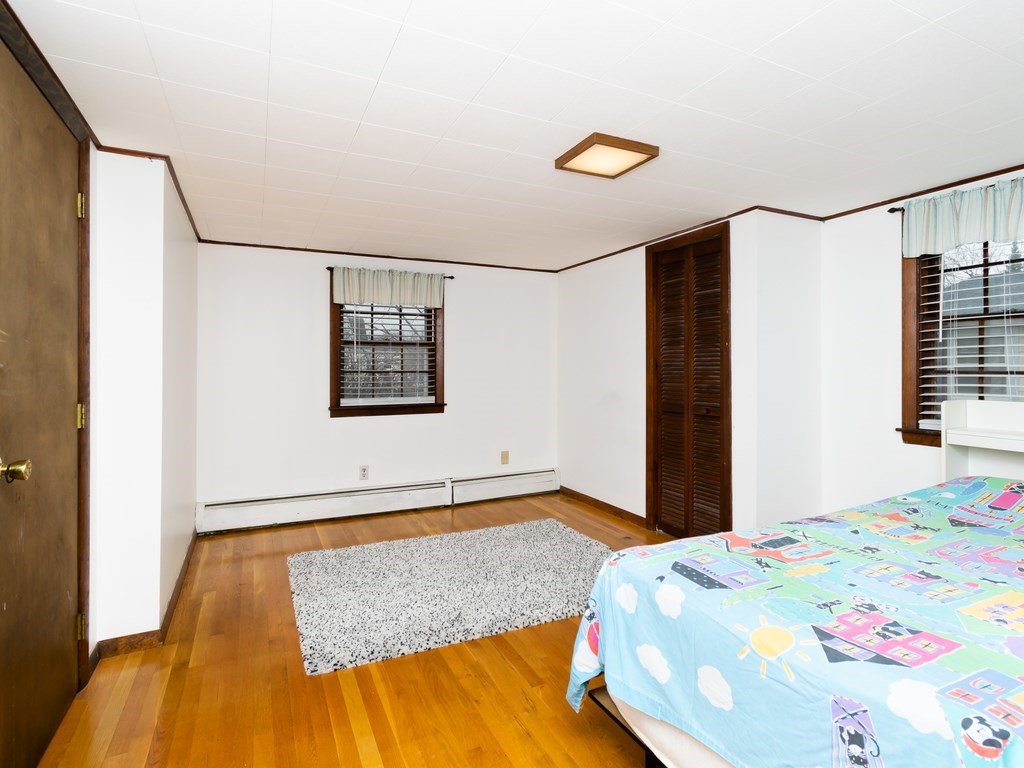 70 Edgemere Road Boston, MA 02132 - Photo 26 of 39 a bedroom with a bed and a window