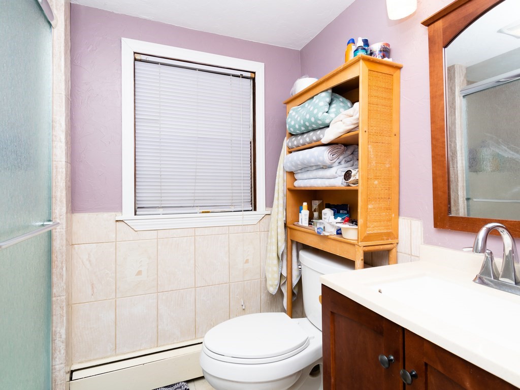 70 Edgemere Road Boston, MA 02132 - Photo 29 of 39 a bathroom with a toilet a sink and a window