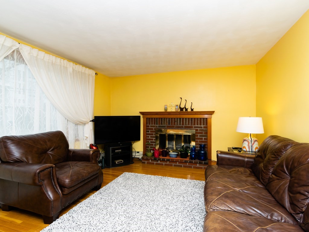70 Edgemere Road Boston, MA 02132 - Photo 7 of 39 a living room with furniture and a fireplace