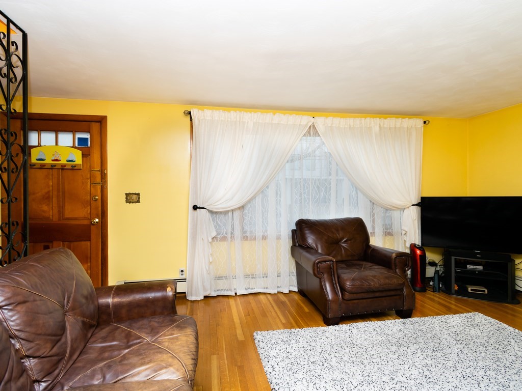 70 Edgemere Road Boston, MA 02132 - Photo 8 of 39 a living room with furniture and a flat screen tv
