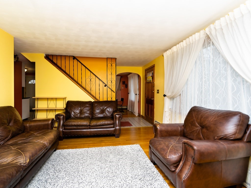 70 Edgemere Road Boston, MA 02132 - Photo 9 of 39 a living room with furniture and a rug