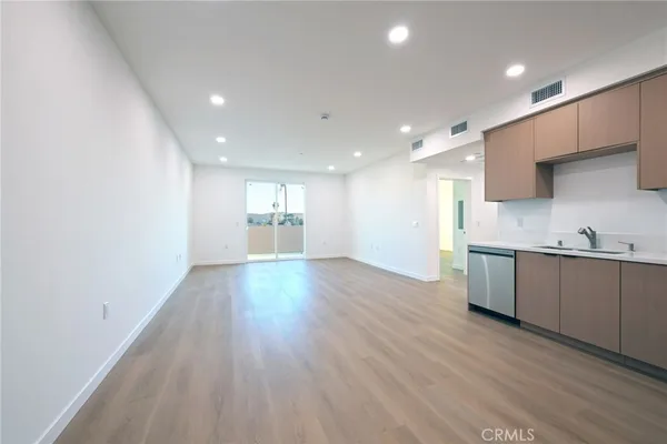 a view of kitchen with sink and wooden floor