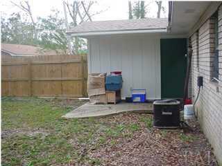8137 Ernestine Road Pensacola, FL 32514 - Photo 2 of 4 UTILITY ROOM WITH PATIO AND BACKYARD PRIVACY FENCE