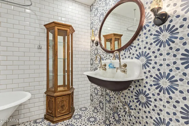 a bathroom with a sink a mirror and a toilet