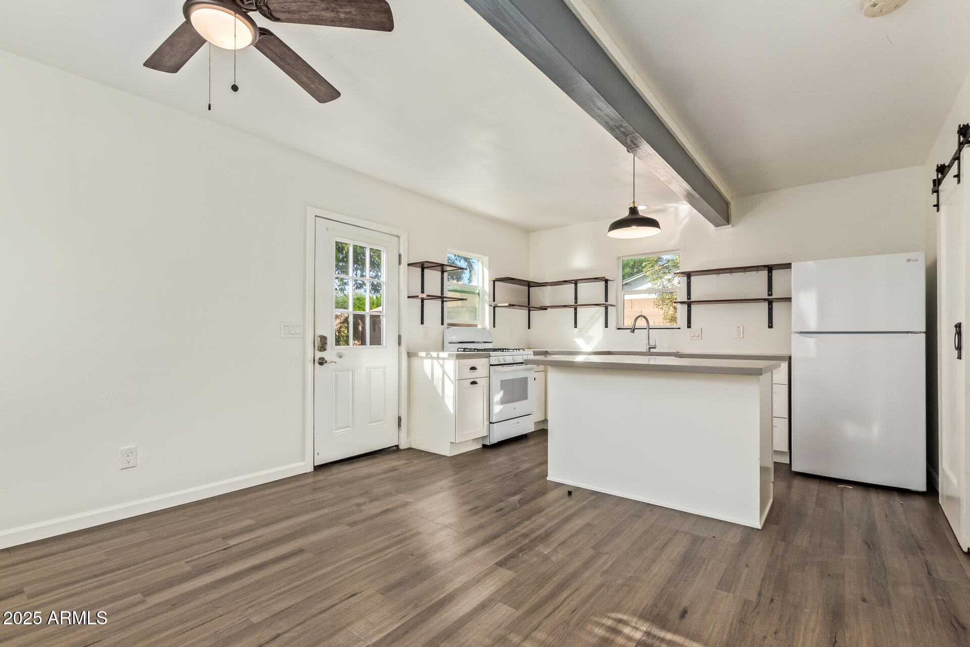 336 Virginia Avenue Phoenix, AZ 85003 - Photo 23 of 29 a kitchen with white cabinets and white appliances