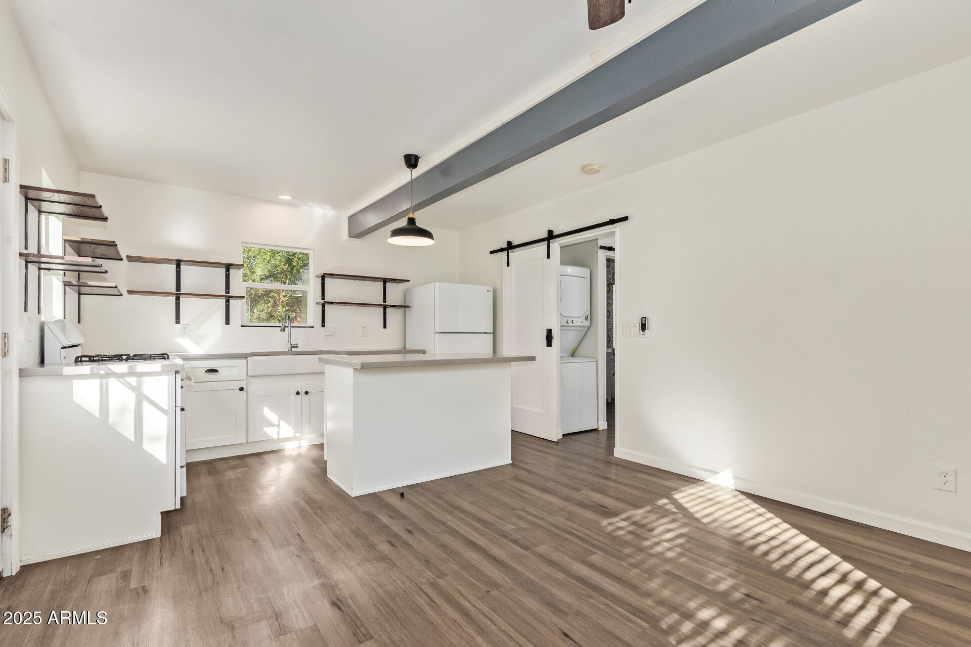 336 Virginia Avenue Phoenix, AZ 85003 - Photo 25 of 29 a kitchen with stainless steel appliances wooden floors and white walls