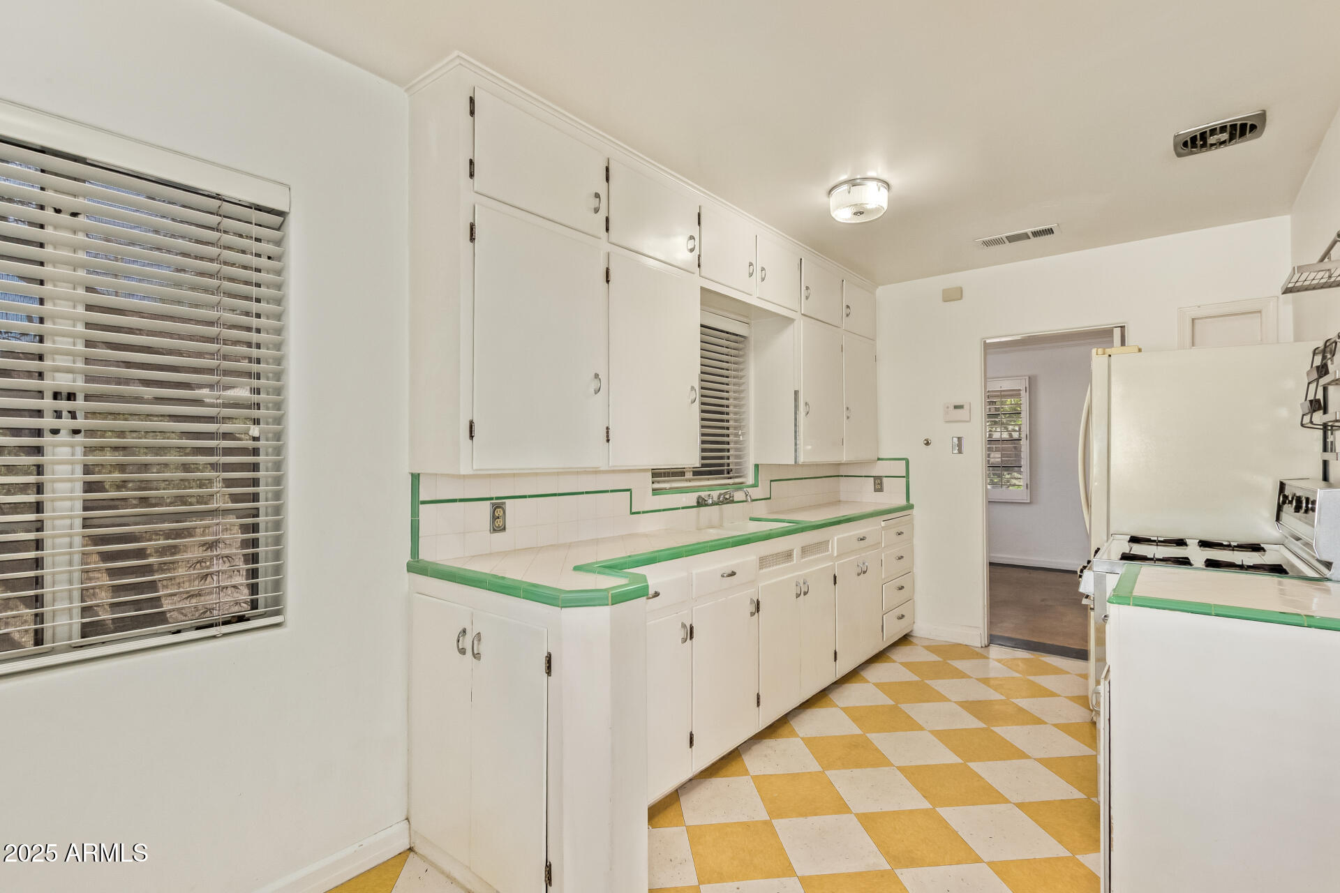 336 Virginia Avenue Phoenix, AZ 85003 - Photo 6 of 29 a large white kitchen with a stove a sink a refrigerator and cabinets