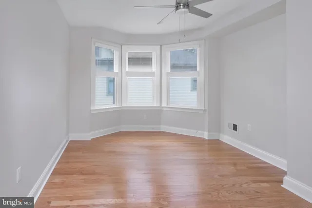 a view of staircase with railing and a window
