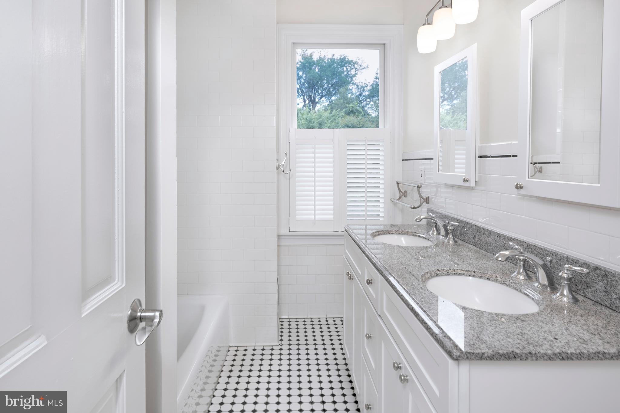 44 Wiggins Street Princeton, NJ 08540 - Photo 22 of 41 a bathroom with a granite countertop sink a mirror and a shower