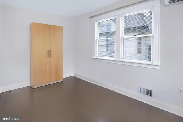 a bathroom with a granite countertop sink a toilet a mirror and shower