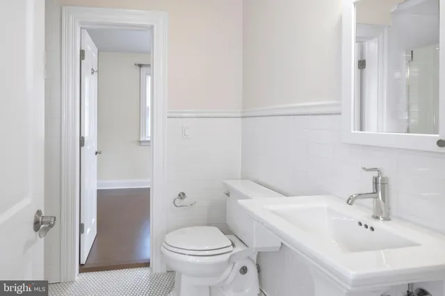 a bathroom with a bathtub a sink and a window