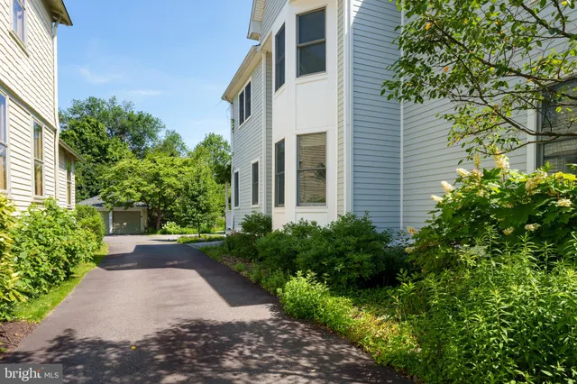 a view of a hallway with wooden floor and entryway